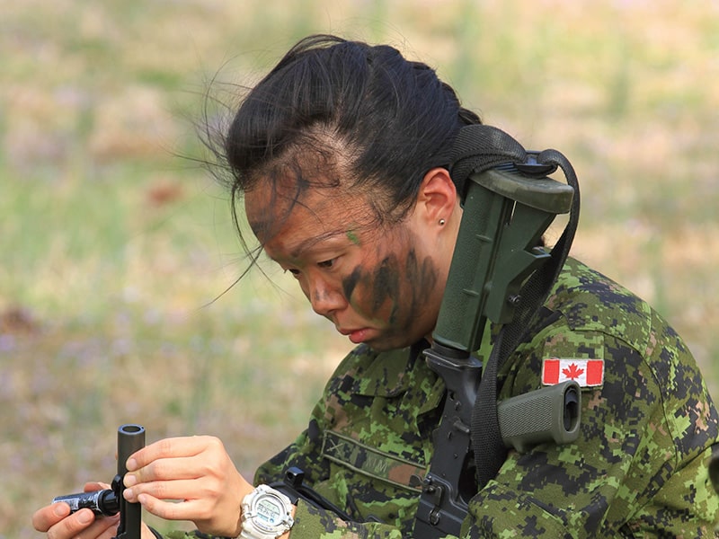Corporal Lisa Kim of the 25 Field Ambulance prepares a C-7 rifle for firing during Exercise Southern Drive 2012. | Image by: Cpl Igor R. Korpan