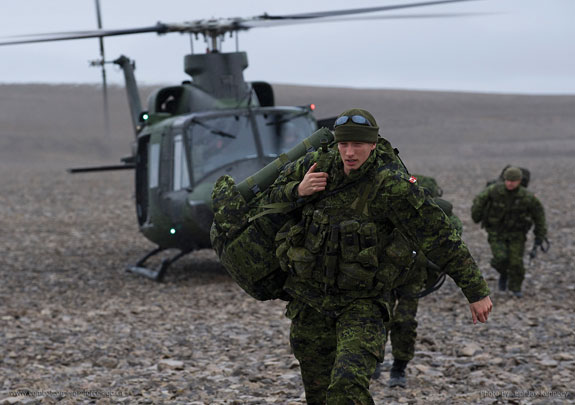 Canadian soldier exiting helicopter
