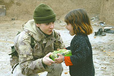 A Soldier giving a gift to a young girl