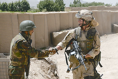 Canadian soldier greets Afghani colleague