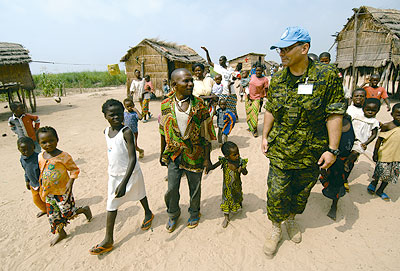 African villagers greet a Canadian peacekeeper 