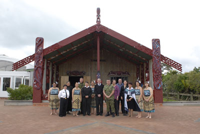 CANZEX participants pose in front of the wharenui
