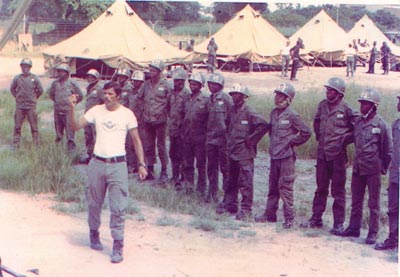 Sergeant Couto, a Portuguese parachutist trainer, and members of the GEP (Grupos Especialis Paraquedistas) training in Mozambique.
