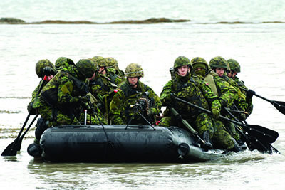 Part of the 900 reservists from the 35th Canadian Brigade Group participating in Exercise Franchissement Audacieux near Charlevoix, Quebec, 1 October 2011. They are crossing the St. Lawrence River in one of 30 inflatable assault boats to attack a fictional enemy on the other side. 