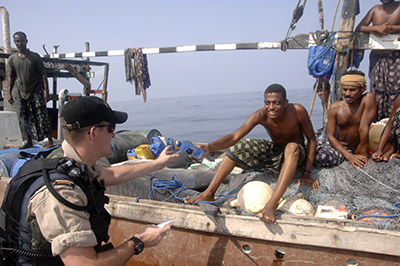As part of their NATO presence patrol in the Indian Ocean in 2007, an away team from HMCS Toronto meets with a group of Yemini shark fishermen at their dhow some 60 kilometres offshore. 