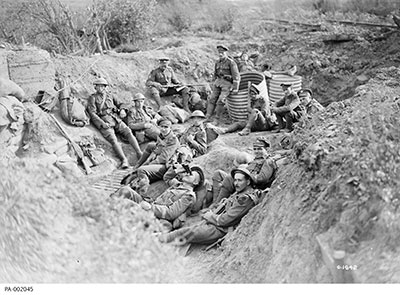 22nd Battalion resting in a shell hole on their way to the front line, September 1917.