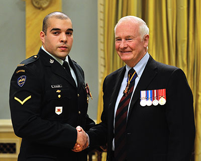 Private St-Hilaire receives his Star of Military Valour from the Governor General at Rideau Hall. 