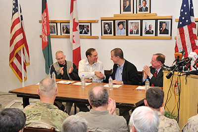 The outgoing Director of the Kandahar Provincial Reconstruction Team (KPRT), Tim Martin, Representative of Canada to Kandahar, and the incoming Director, Ben Moening, shake hands during the Transfer of Authority (TOA) of the KPRT to the USA, 12 January 2011.