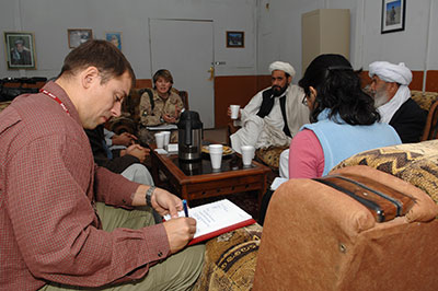 Nicholas Gosselin, Political Officer for the Department of Foreign Affairs working with the KPRT, records notes during an exchange of information with Afghan officials regarding the functioning of the Afghan justice system, 29 November 2007.