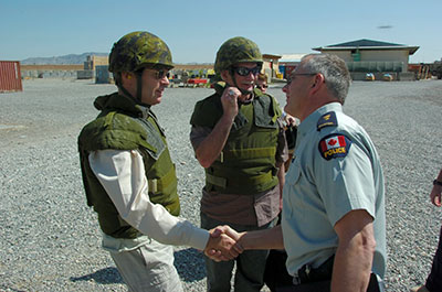 The Kandahar Provincial Reconstruction Team’s Senior Police Advisor, RCMP Superintendent Dave Fudge, greets the Honourable Stockwell Day, Minister of Public Safety, and the Honourable Vic Toews, the Treasury Board President, shortly after their arrival at the KPRT’s Camp Nathan Smith, 2 April 2007.