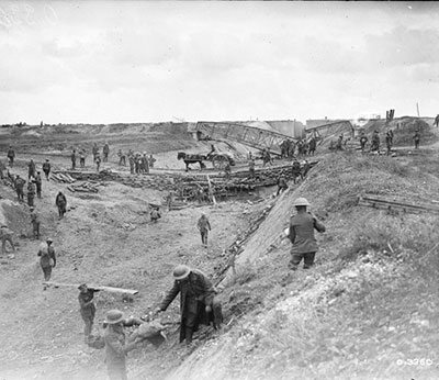 Canadian transport moves across makeshift bridges constructed in the dry bed of the Canal du Nord.