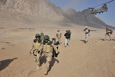 Government of Canada senior officials land in the Panjwai’i District, Afghanistan, 12 January 2011. They included the Clerk of the Privy Council, Mr. Wayne Wouters, the Vice-Chief of the Defence Staff, Vice-Admiral Bruce Donaldson, and the Deputy Minister of the Afghan Task Force of the Privy Council Office, Mrs. Greta Bossenmaier.