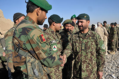 Senior Afghan and Canadian service members monitor development projects in Dand District, 18 January 2011.