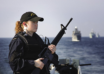 female sailor holding rifle