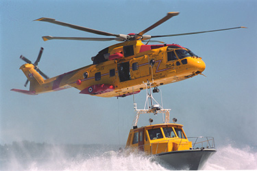 Cormorant helicopter over a rescue launch