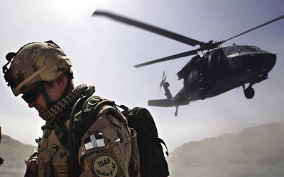 A Canadian soldier turns his back on a Blackhawk helicopter taking off from the forward operating base at Ma’sum Ghar, 1 July 2007.