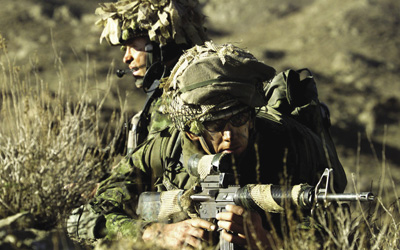 Scouts from the 3rd Battalion, Princess Patricia’s Canadian Light Infantry (3 PPCLI) Battle Group, advance into a ravine to search caves for Taliban and al Qaeda fighters during Operation Anaconda, 15 March 2002.
