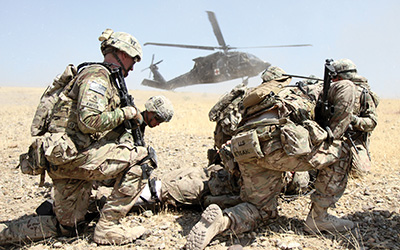 A combat team from the 101st Airborne Division prepare a simulated casualty for evacuation in Afghanistan, 2015.