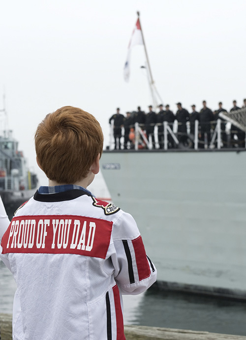 A child saying goodbye to his father heading out on a naval deployment in 2014.